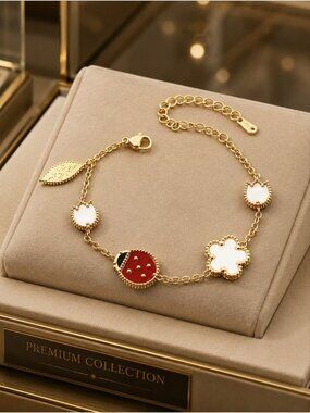 Gold-tone Bracelet with White Clover and Red Ladybug Accents